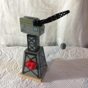 Vintage Thomas Train Set Crane. Hand Crank Turning Crane. Crank on Other Side Retracts Magnetic Picker-Upper. Thomas Face on Crane.