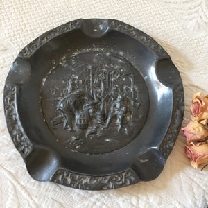 Vintage Pewter Ash Tray With Colonial Tavern Type Scene in 3D Relief. Edge Has Swirling Designs Molded In. Heavy and Well Made Ash Tray.