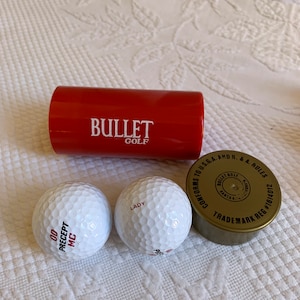 Vintage Golf Balls in Van Leeuwen Pipe and Tube Plastic Container. 2 Bullet Golf #1814012 Golf Balls. Conforms to USGA and R & A Rules.