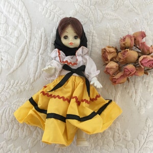 Vintage Hard Plastic Doll With Rick Rack Trimmed Ruffled Dress. Black Bandana. Moveable Legs, Arms and Head.