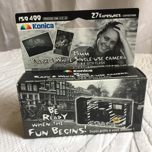 May include: A black and white disposable camera with a zebra print design. The camera has a built-in flash and says "Be Ready When The Fun Begins!" on the front. The box says "35mm Black & White Single-Use Camera" and "Monochrome Film-In With Flash".