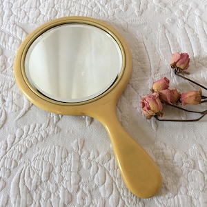 Vintage Yellow Celluloid Hand Mirror. Beveled Glass in Yellow Celluloid Frame. Heavy and Well Made.