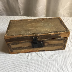 Antique Doll Trunk Paper Over Wood with Front Latch Opens Without Key. One Leather Handle. Good For Display. Rustic Condition.