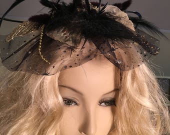 Fascinator With Sparkly Leaves, Black Soft and Spiky Feathers, and Black Veil With Stars. Hair Clip on the Back. Gold Bead Accents.