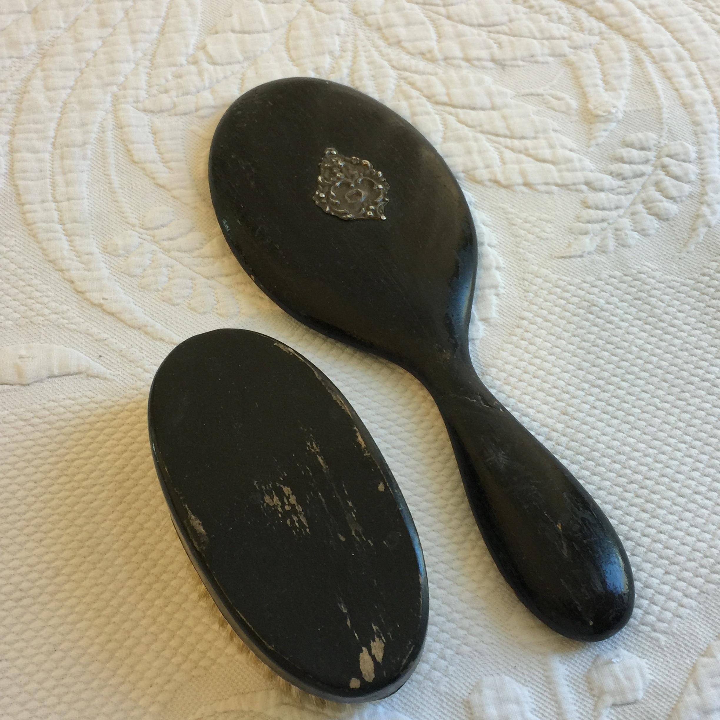 Antique Hand Mirror and Brush. Black Wood Oval Beveled Mirror with Silver Plate Back Ornament and Oval Natural Bristle Brush w/ Silver Base.
