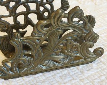 Vintage Napkin Holder. 1980 Teleflora Brass Napkin Holder. Mixture of Designs: Waves, Swirls, Flowers, Leaves & Butterfly. Openwork Designs.