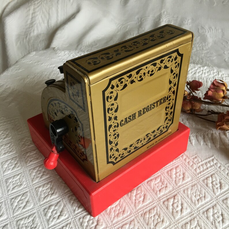 Gold With Black Print and Designs With Red Bottom Vintage Toy Cash Register Black and Red Plastic Handle Push Buttons to Raise Numbers.