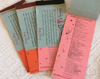 May include: A pink and blue Disneyland ticket booklet with a checklist of attractions. The cover features a cartoon fairy and the text "Welcome to Disneyland".