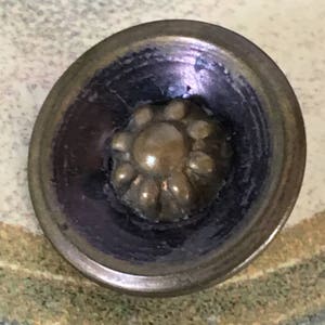 Antique 3 Buttons. Aged Gold Buttons With Dimensional Center Flower Design Sitting in a Bowl Type Area in the Button.