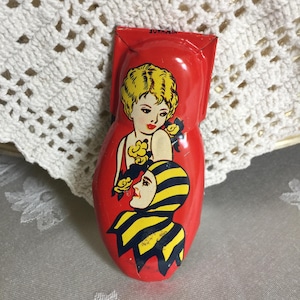 Vintage Metal Clacker Noise Maker for Celebrations. Jester and Lady on Front. Push Clicker Noise Maker on Back for a Loud Clicking Noise.