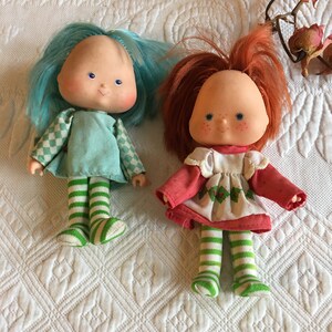 Vintage Purple Pieman, Blueberry Muffin and Strawberry Shortcake Used Dolls. The Girl Dolls are Dressed and the Purple Pieman has a Hat.