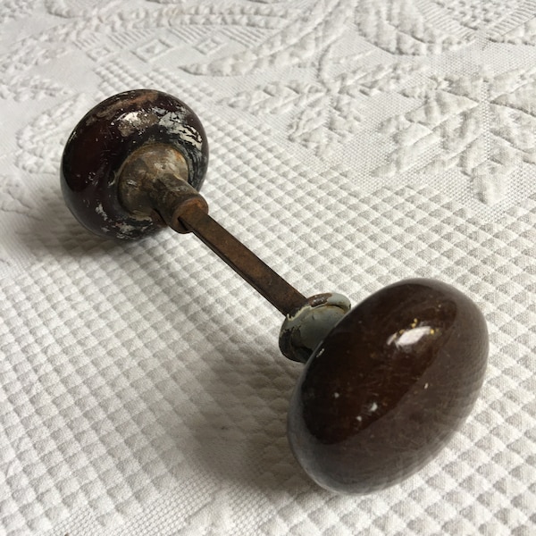 Victorian 2 Brown Porcelain Doorknobs. One Doorknob has a Small Crack from Age. Some Old Paint on the Knobs.