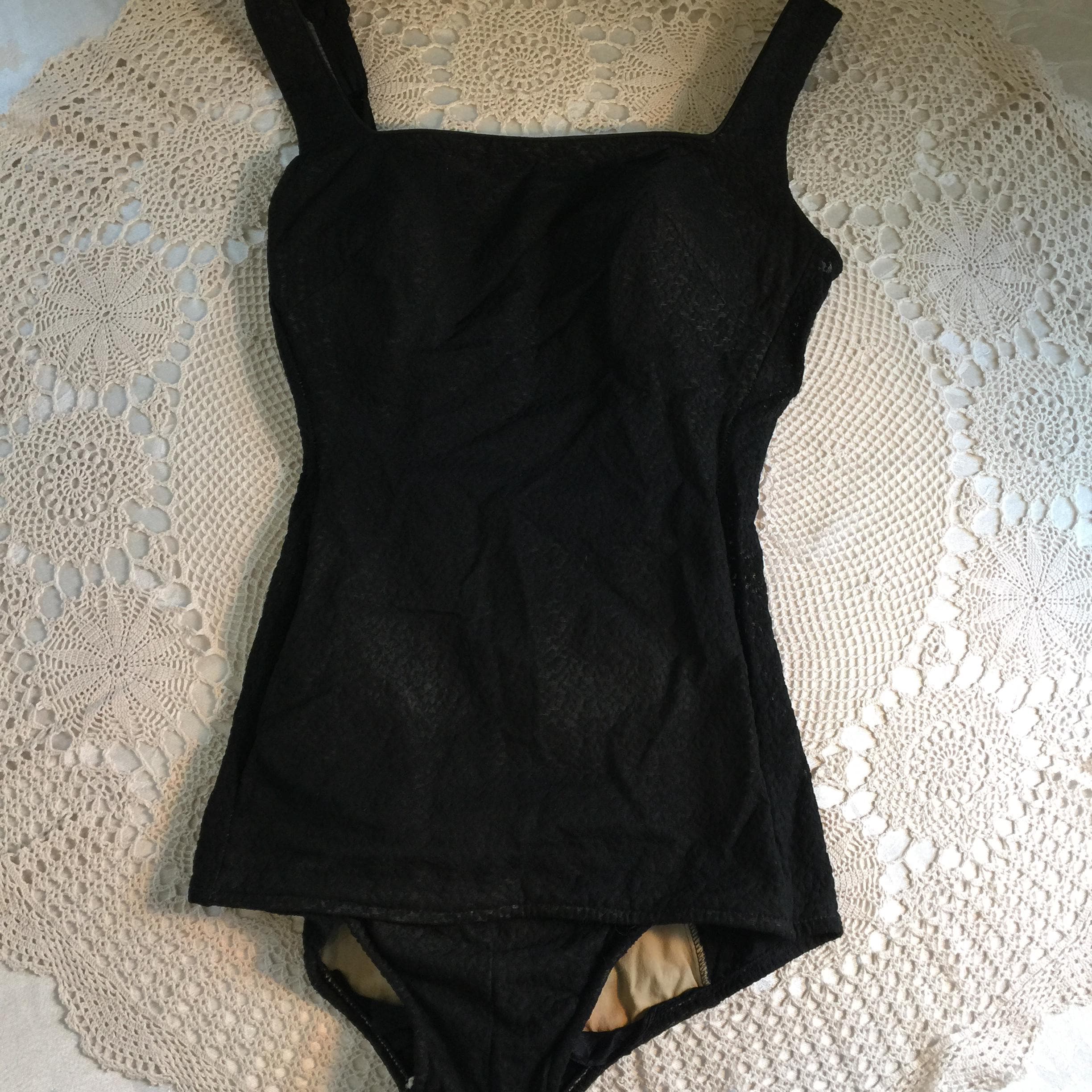 Vintage 1970s Cole of California Size 12 Black Lace Look One Piece Swimsuit. Sold by Saks Fifth Avenue. Flap Low in Front. Button Straps.