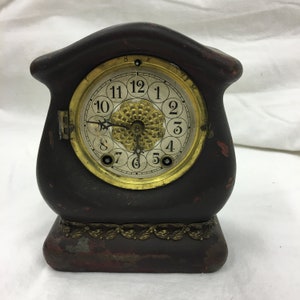 Antique 1891 Waterbury Clock Co. Mantel Clock. Metal Case May Have Been Covered in Leather. Curved Lines w/ Gold Metal Ornaments. No Glass.