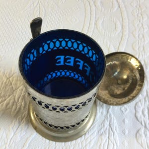 Vintage Coffee Container. Hammered Silver Plate Openwork Design w/ Lid and Spoon. Cobalt Blue Hard Plastic Liner and Spoon Holder. image 7