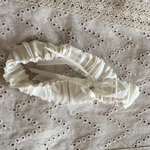 Vintage Garter. Elastic Covered in Creamy White Satin With Ribbon and Rhinestone Diamond. Ready for a Wedding Celebration.