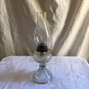 Antique Clear Glass Oil Lamp With Hurricane Shade. Square Pattern in Glass Oil Tank. Sunburst Lines on Bottom Pedestal.