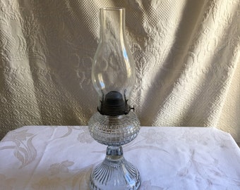 Antique Clear Glass Oil Lamp With Hurricane Shade. Square Pattern in Glass Oil Tank. Sunburst Lines on Bottom Pedestal.