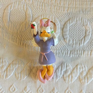 NewVintage 1991 Grolier Daisy Duck Angel Disney 007907 DCA Daisy Duck Ornament. Daisy Angel in Purple Dress With Mistletoe. In Original Box.