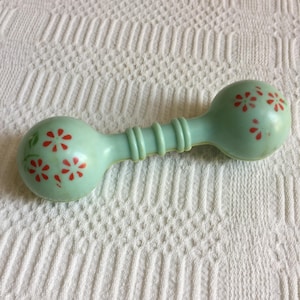 Vintage Baby Rattle. Green Plastic with Red Flowers and Green Leaves. Gentle Rattle Sound. Great for a Vintage Display.