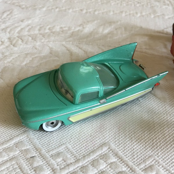 Vintage Disney Pixar Teal Car with Large Fins on Back. Car with Moving Eyes in Windshield, Silver Smile and Off-Center License Plate.