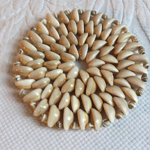 Vintage Seashell Mat or Trivet. Plastic Wired Shells Laying on Their Sides w/ Smaller Shells Decorating the Edge. Great for a Plant.