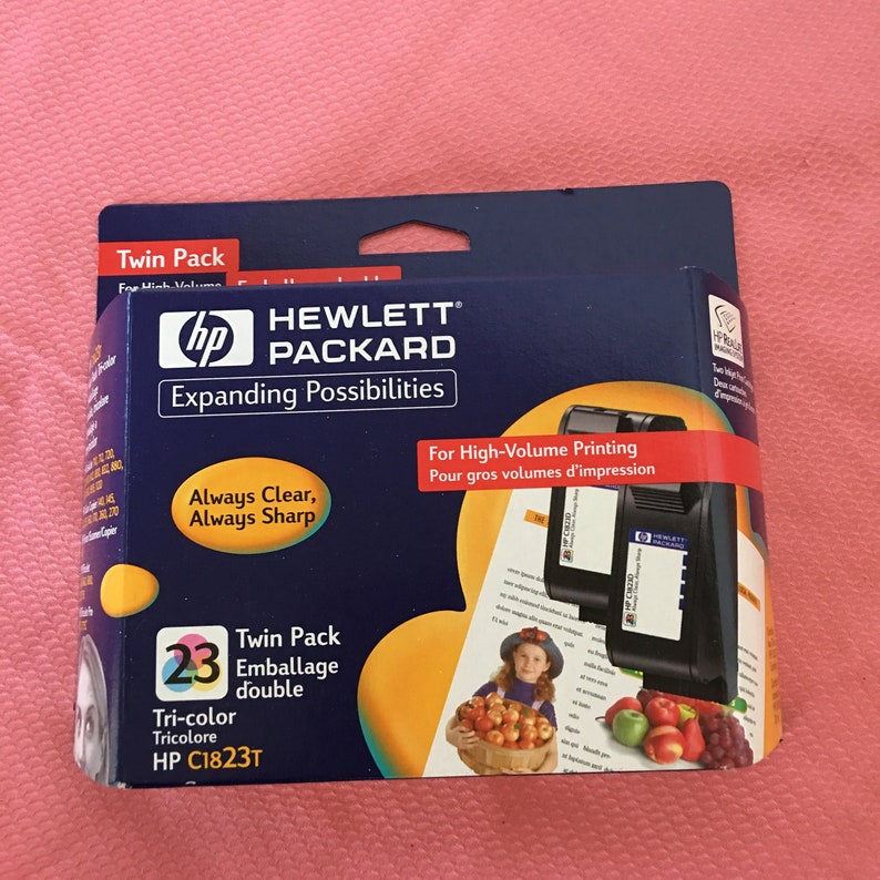 Puede incluir: Paquete doble de cartuchos de tinta tricolor HP C1823T para impresoras Hewlett Packard. El embalaje es azul y amarillo con el texto "Expanding Possibilities" y "Always Clear, Always Sharp".