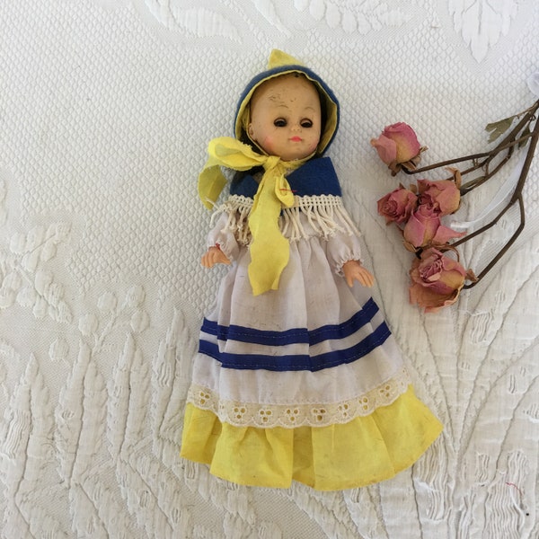 Vintage White Blue and Yellow Dressed Doll With Light Blue Blinking Eyes, Coral Lips. Plastic Doll With Long Dress, Fringed Shawl and Hat.