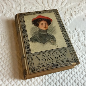 Antiguo libro de 1914. Un marimacho moderno de la Sra. L.T. Meade. Imagen de la portada de R. Ford Harper. Publicado por Grosset & Dunlap.
