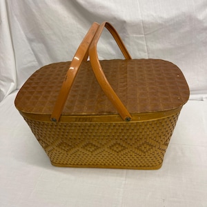 Vintage Red Man Quality Baskets Picnic Basket. Label Inside Back. Woven Wicker w/ Design, Masonite Hinged Lid and Painted Metal Handles.
