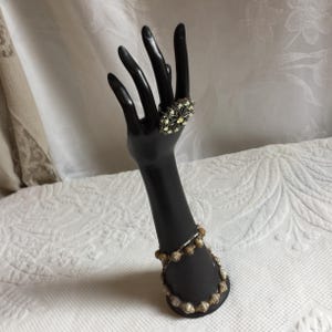 Vintage Black Composite Hand and Arm Figurine Decorated with Beads Around Forearm. Use to Hang Rings or Other Jewelry.