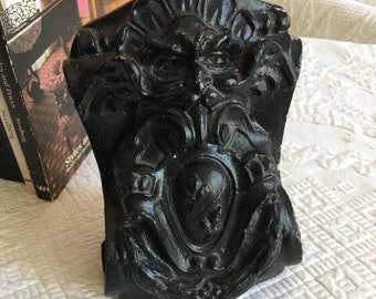 Antique Chalkware Bookends with Father Wind Fancy Shield Type Decoration. Black Cast Chalk Scroll and Architectural Details. Doorstop Also.