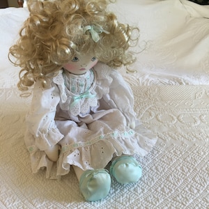 Vintage All Fabric Doll with Blonde Shiny Curls and a Pouty Look on Her Beautiful Face. Lovely Eyelet and Ribbon Dress. Mint Green Accents.