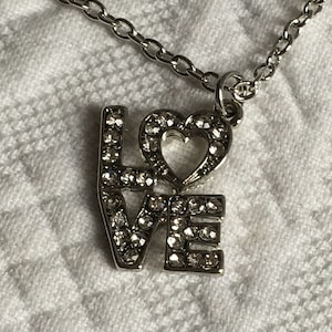 Beautiful Rhinestone Love Pendent Necklace. 26&quot; Chain Silver Tone Necklace with Love Pendent with Heart for the Zero.