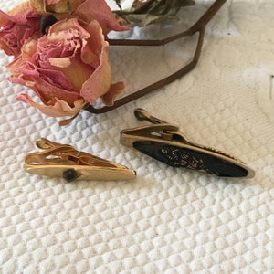 Vintage 2 Tie Clips With Black on Gold. One Swank, With Gold Arrow Design With Square of Black Glass, One With Black and Gold Designs.
