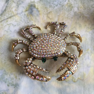 Vintage Heidi Daus Rhinestone Crab Pin Brooch. Gold Tone Setting with Iridescent Clear Rhinestones and Green Eyes.