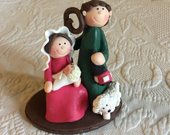 Vintage Clay Type Nativity on Oval Base. Maybe Femo Formed. Joseph is Holding a Lantern, Mary is Holding Baby Jesus and Lamb at Feet.