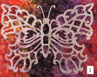 May include: A white butterfly-shaped cutout on a red, orange, and purple fabric background. The fabric has a tie-dye pattern. The number "1" is in the bottom right corner of the image.