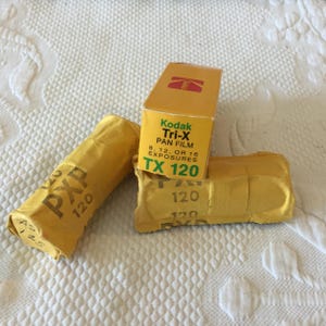 Vintage Kodak Tri-X Pan Black and White Film TX 120 sealed in Box Dated 1976, and Two Rolls of PXP 120 Film Sealed in Paper.