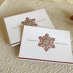 Twenty Season&#39;s Greetings Cards W/ Snowflake Cutout Revealing Red and Silver Leafy Snowflake Inside. Paper Magic Group.