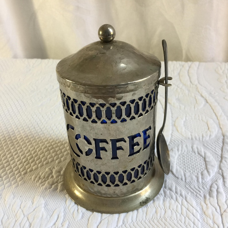 Vintage Coffee Container. Hammered Silver Plate Openwork Design w/ Lid and Spoon. Cobalt Blue Hard Plastic Liner and Spoon Holder. image 1