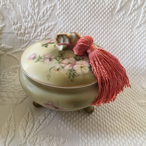 Vintage Nippon Porcelain Hand Painted Dresser Jar with Three Feet and Top Shell Shaped Handle. Green and Pink Flowered Nippon Porcelain.