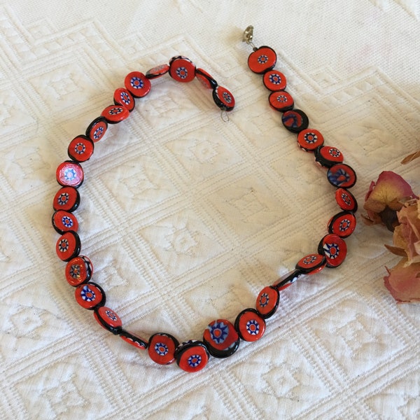 Vintage Venetian Murano Orange Glass Necklace. Round Flat Disks of Star Designs on Orange, Blue and White Millifiori Beads. Lobster Closure.