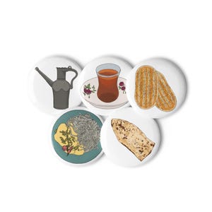 May include: A set of five circular pinback buttons featuring colorful illustrations of a dark grey metal ewer, a glass of amber tea on a floral saucer, two golden brown oval crackers, a plate of yellow noodles, and a piece of flatbread.