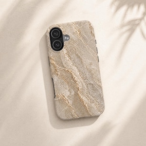 May include: A smartphone case with a marble design. The case is primarily beige with gold-colored veining, and has a dual-lens camera cutout at the top. The case has a smooth, polished appearance.
