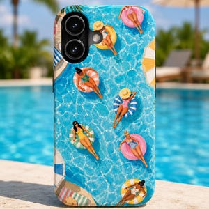 May include: A smartphone case featuring a vibrant aerial view of a swimming pool with multiple figures floating on colorful circular inner tubes. The design includes various swimsuits, sun hats, and pool accessories against a bright blue water background.