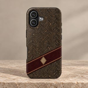 May include: A smartphone case featuring a dark brown and black herringbone pattern. A diagonal deep red band with thin gold borders crosses the lower section, centered with a small, textured gold diamond-shaped emblem near the bottom edge.