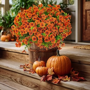May include: A wooden barrel overflowing with vibrant orange flowers, complemented by three pumpkins and autumn leaves. The pumpkins vary in size, creating a seasonal fall display on a wooden porch.
