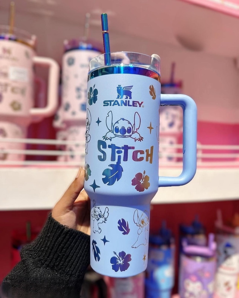 May include: A set of three ceramic mugs with a speckled, matte finish. The mugs are in shades of cream, light gray, and dark gray. Each mug has a simple, minimalist design and a rounded handle.