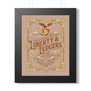 May include: A framed print featuring a tan background with an ornate gold border. The text reads Liberty & Ledgers, Distilled in Satoshi's Whitepaper, 100% Peer-to-Peer, and Bottled in the USA, with a central shield containing a Bitcoin symbol.